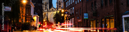 Sundown of central York  UK  with York Minster cathedral on the back. Car traffic trail lights in York  UK