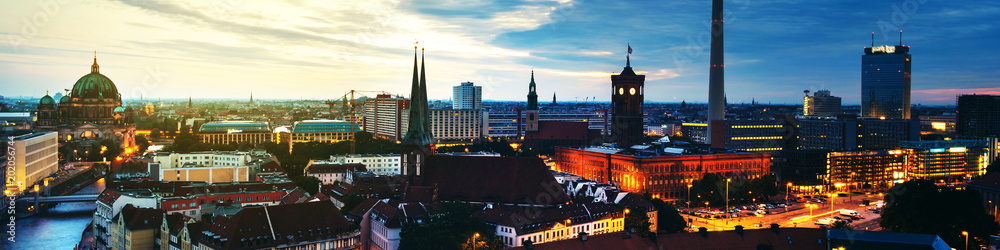 Naklejka premium Illuminated landmarks in Berlin, Germany in the morning. Colorful cloudy sky