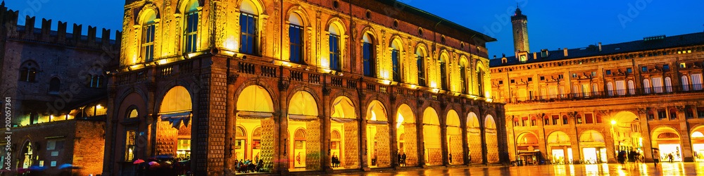 King Enzo palace at the main square of Bologna, Italy. Famous landmark at sunset at night.