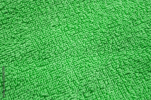 Green towel background, texture of cotton fibers of bath towel close up