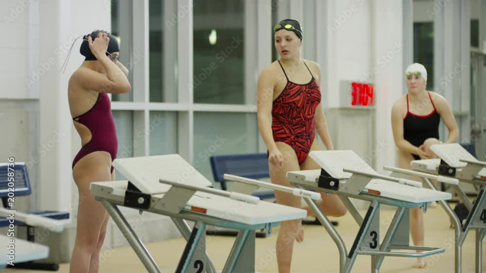 Slow motion shot of girls warming up before swimming race / Provo, Utah, United States Slow motion shot of girls warming up before swimming race / Provo, Utah, United States