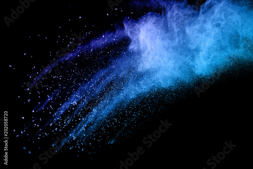 color powder explosion on black background. Mauve color cloud. Freeze motion painted Holi.