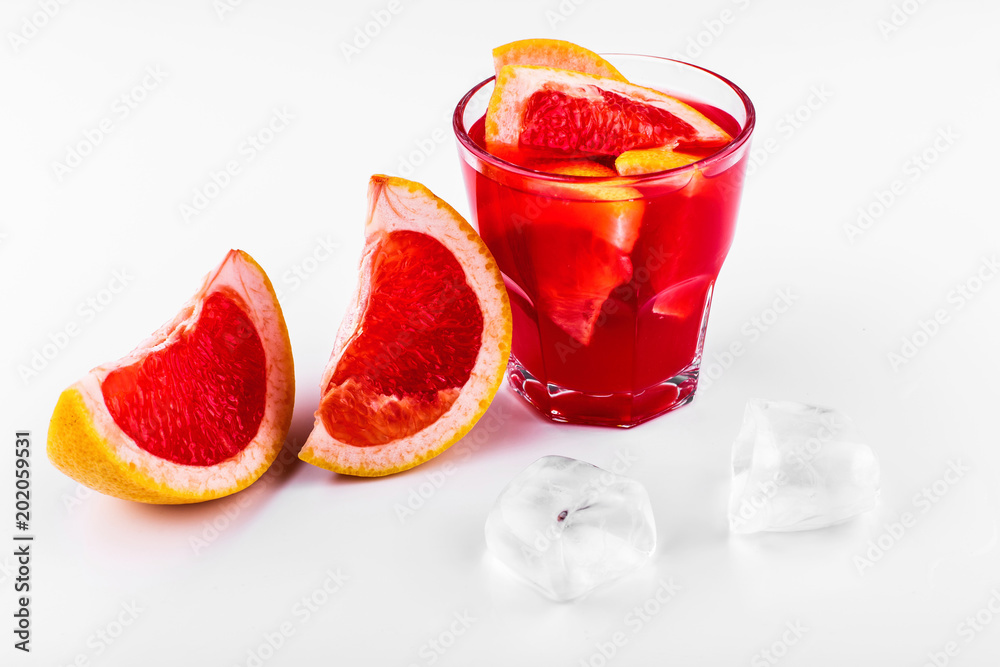 Blood orange gin and tonic cocktail served with slices of orange and ice in a glass on white background Blood orange gin and tonic cocktail served with slices of orange and ice in a glass on white background