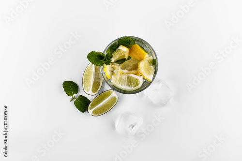 Mojito refreshing non alcohol cocktail  drink in highball glass with soda water, lime lemon juice, mint leaves, sugar, ice and rum photo