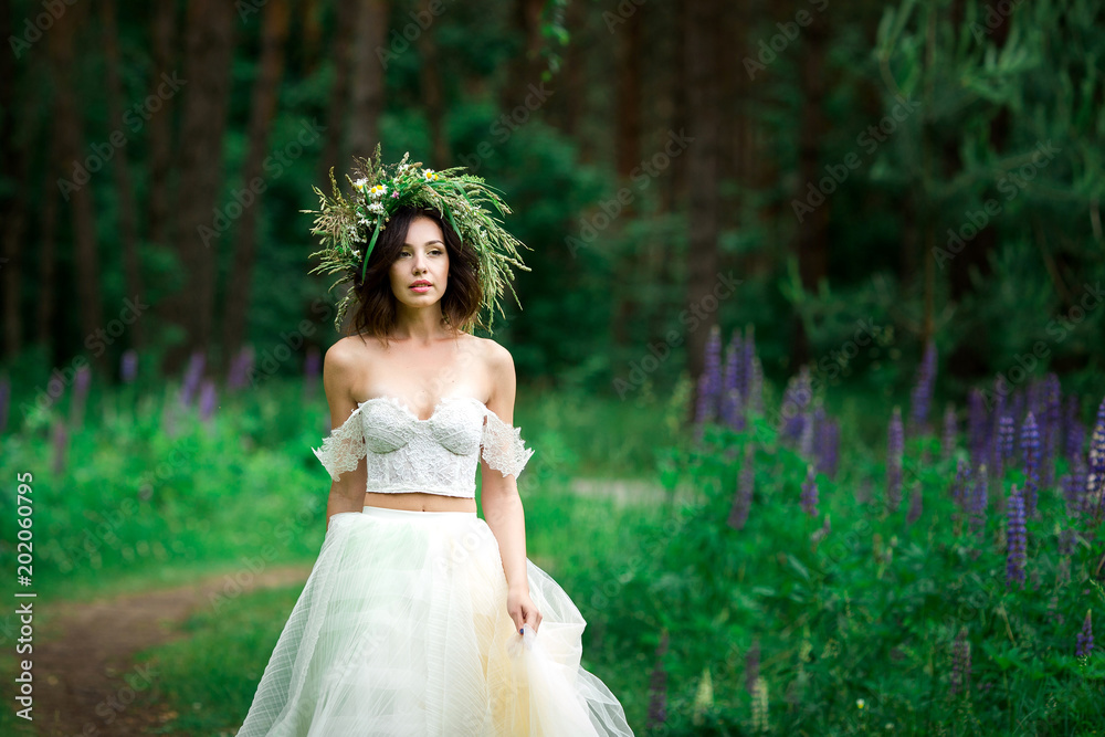 Portrait of a beautiful bride in a white dress and a wreath Portrait of a beautiful bride in a white dress and a wreath