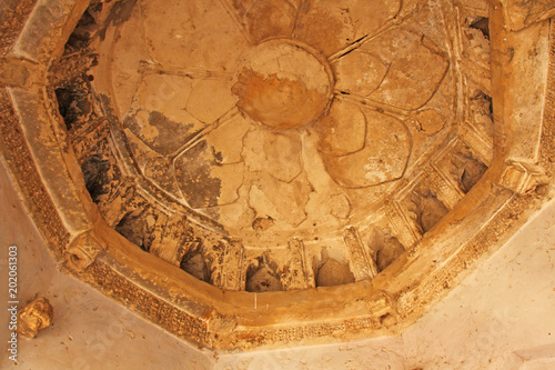 Queen baths in Hampi, Karnataka state, India. Carving stone ancient background. Unesco World Heritage Site. Geometric carved patterns on the ceiling photo