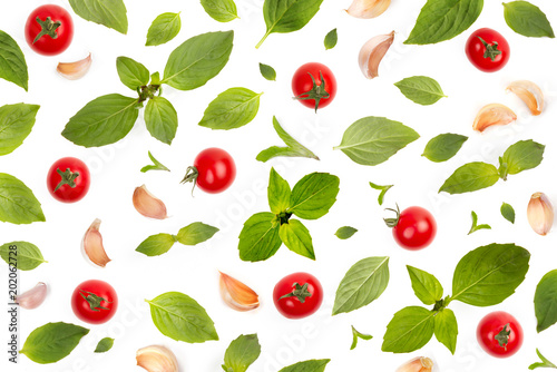 Fototapeta Naklejka Na Ścianę i Meble -  Pattern of Basil leaf and garlic clove with tomatoes. Kitchen and Ingredient wallpaper with abstract composition of vegetable concept