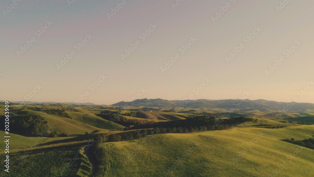 Tuscany hills landscape at sunset aerial view