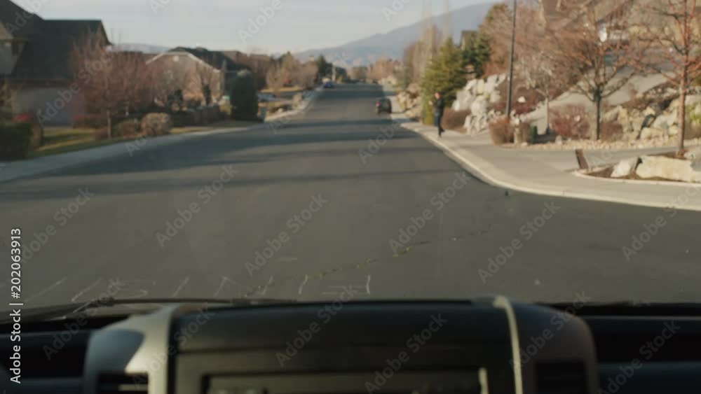 Car hitting distracted man crossing street while texting on cell phone / Cedar Hills, Utah, United States