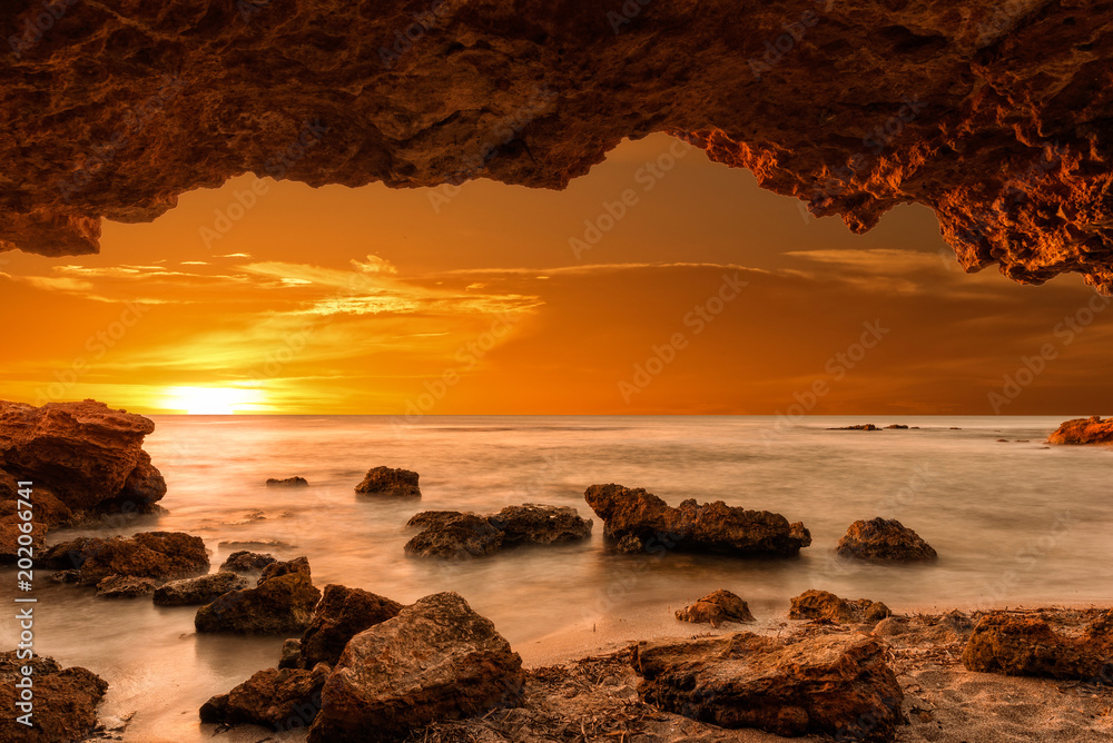 Sunrise at the sea from a cave