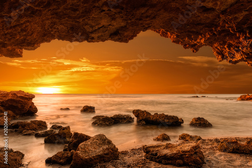 Sunrise at the sea from a cave