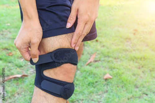 The man wear Knee Support with sunlight in the park / Brace Knee Pads Leg 