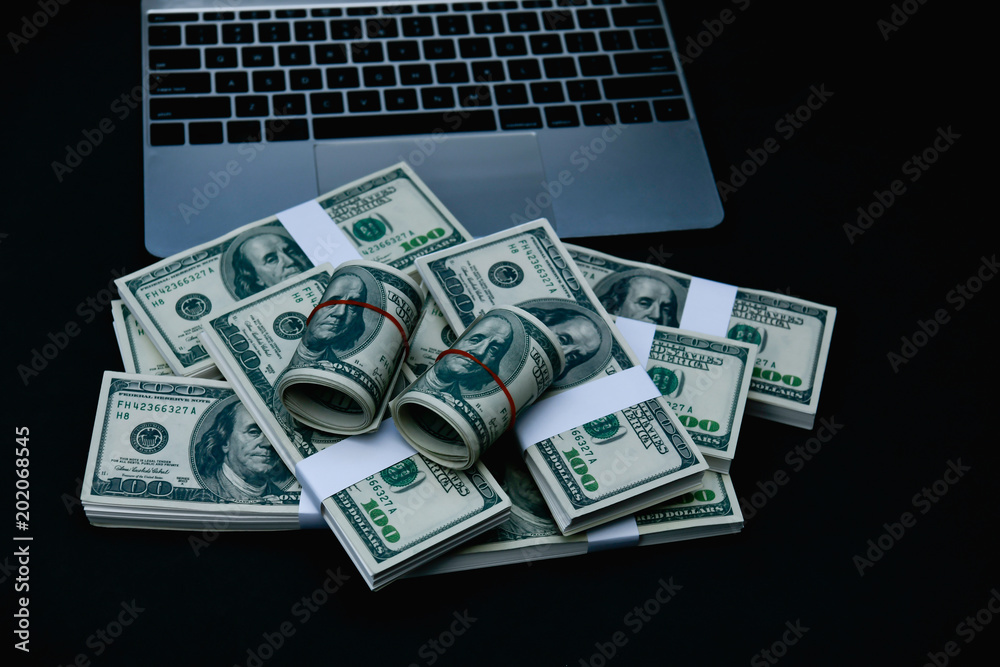 Finance Business Concepts. Lots of money on a black background. Investments are a necessity of business. Businessman looking at a lot of money. Finance Business Concepts. Lots of money on a black background. Investments are a necessity of business. Businessman looking at a lot of money.