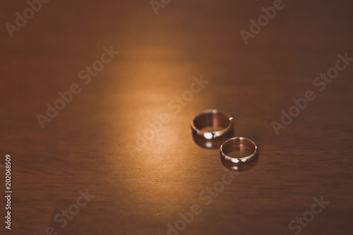 Wedding rings on a brown table 1144.