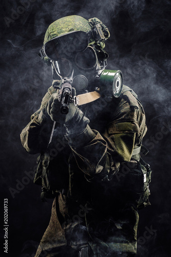 russian special forces soldier with rifle on dark background. army, military and people concept