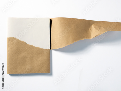 Stack of white paper in peeled brown wrapper