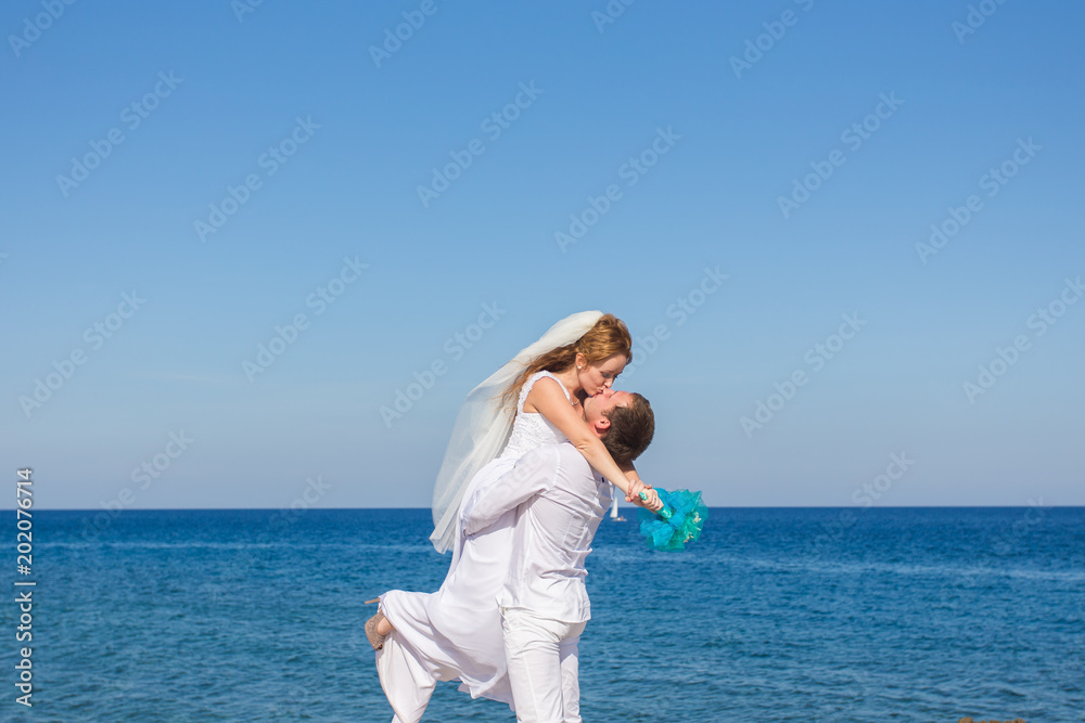 Bride and groom by the sea on their wedding day