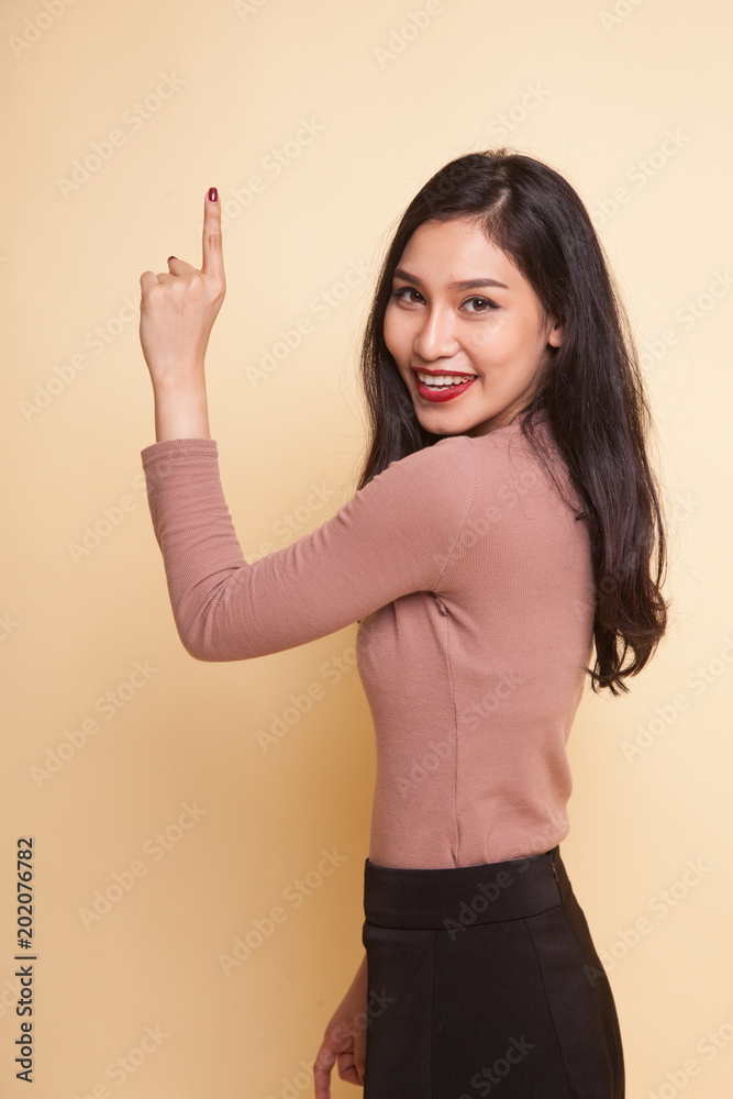 Back of Asian woman touching the screen with her finger. Back of Asian woman touching the screen with her finger.