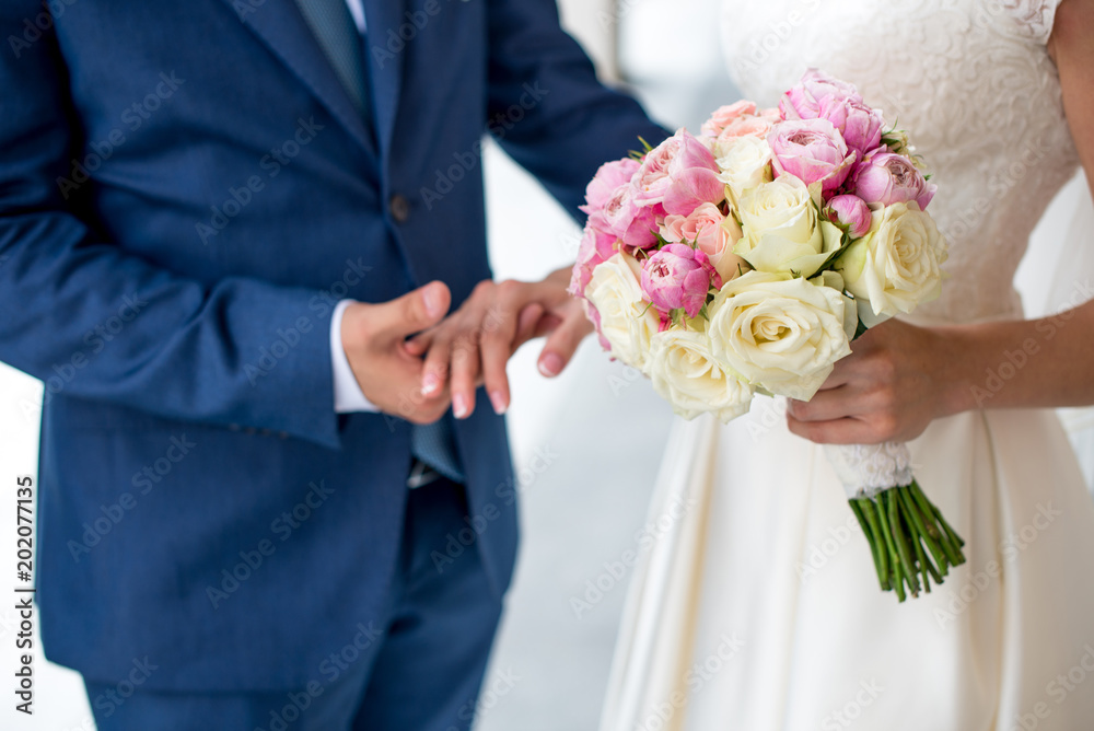 beautiful delicate Bridal bouquet of white, pink roses and flowers in hands of bride. beautiful delicate Bridal bouquet of white, pink roses and flowers in hands of bride.