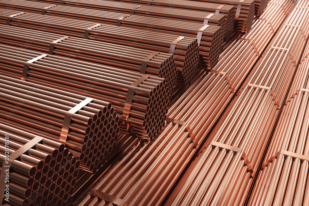 Stack of copper pipes in warehouse. Rolled metal products.