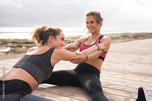 Young healthy women doing stretches outside