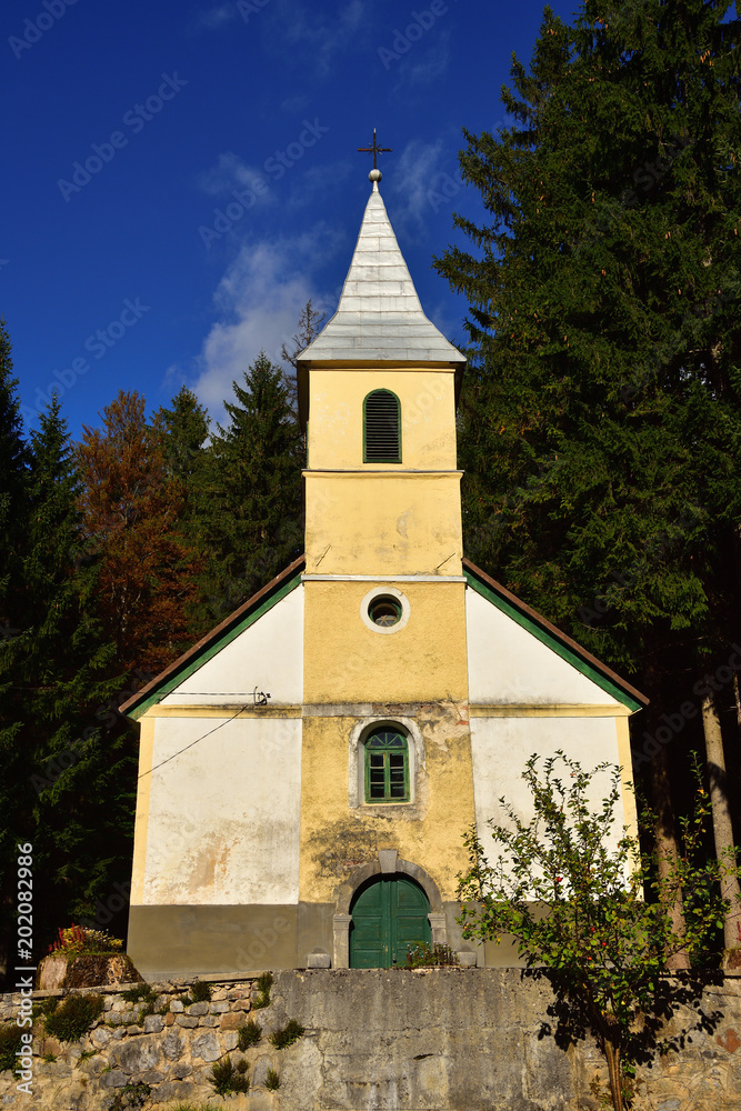 Old small catholic church in countryside area in Croatia. 