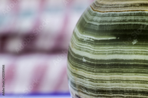 Fototapeta Naklejka Na Ścianę i Meble -  Macro photo texture of polished onyx stone on a motley background.Photo for the site about geology, stones, jewelry,handwork, textures,art, astronomy.