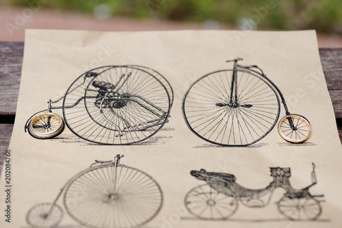 Wedding rings on a paper with retro bike illustration.