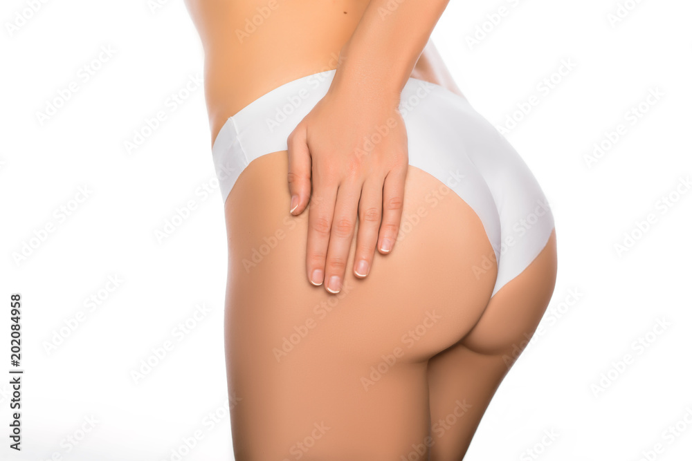 perfect slim woman body, butt in white panties closeup. Tight hips and firm buttocks . - obrazy, fototapety, plakaty 