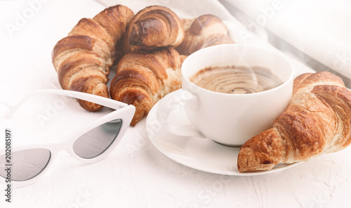 croissants with a cup of coffee on a white background