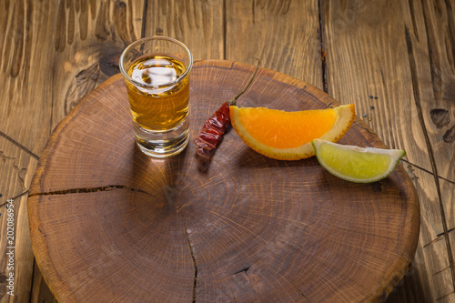 Mezcal shot mexican drink with orange and lime slices, chili in oaxaca mexico photo