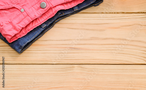 Children's or women's clothes on wooden background