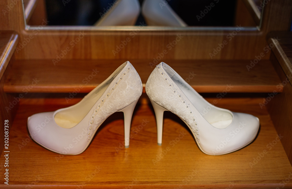 White female shoes on a wooden background White female shoes on a wooden background