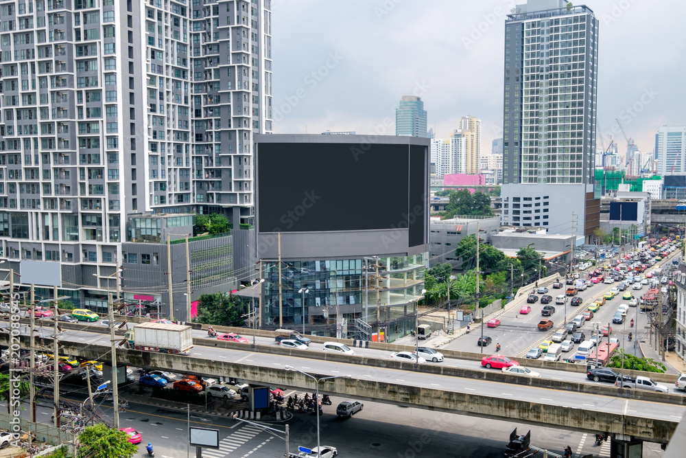 Large billboard on building with crowded traffic in bangkok