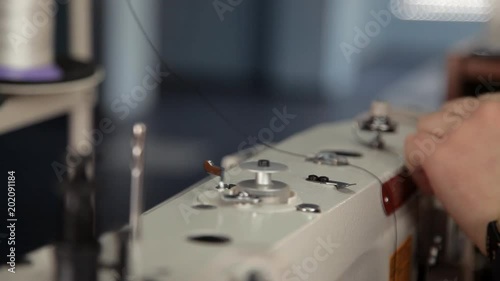 A man prepares a sewing machine to work photo