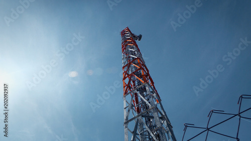 Communication Tower against blue sky and sun flares