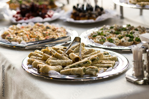 holiday buffet table served by different canape, sandwiches, snacks ready for eating in restaurant