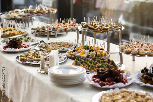 holiday buffet table served by different canape, sandwiches, snacks ready for eating in restaurant