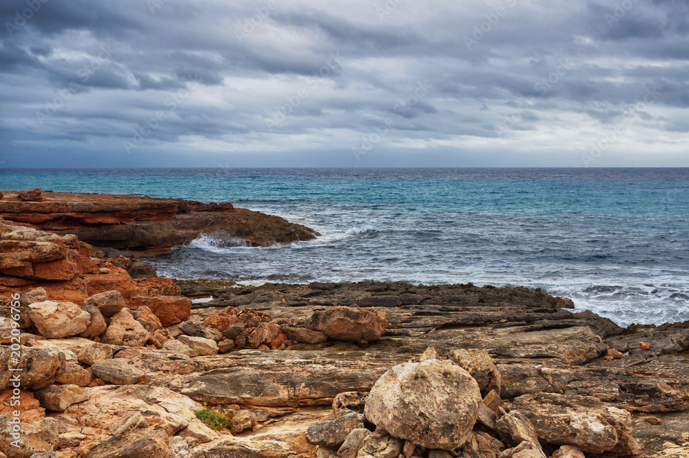 Rocky beach under a gloomy dramatic sky