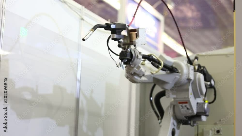 A robotic arm. Automatic welding robot in a modern factory in operation. Assembly line A robotic arm. Automatic welding robot in a modern factory in operation. Assembly line