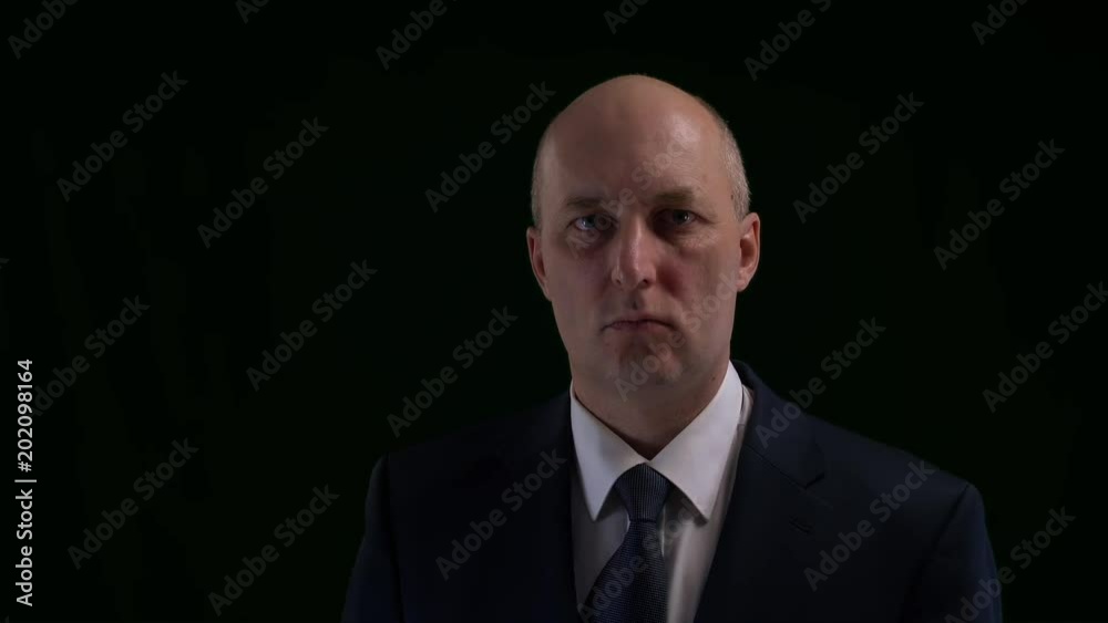 Respectable man in business suite correcting tie and looking on wristwatch. Sequence: modern businessman. Respectable man in business suite correcting tie and looking on wristwatch. Sequence: modern businessman.
