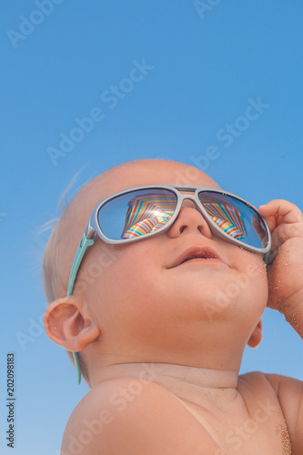Happy funny smiling cute baby boy with sunglasses
