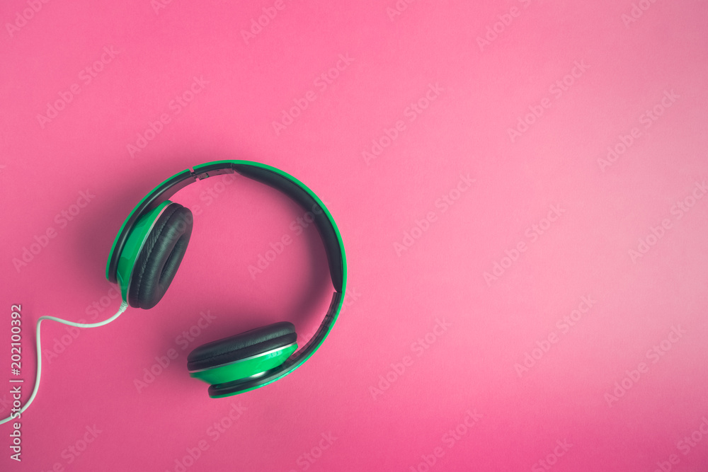 High angle view of headphones on rose background creative music concept. High angle view of headphones on rose background creative music concept.