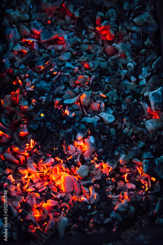 Hot coals and burning woods in bbq grill. Close-up, top view.