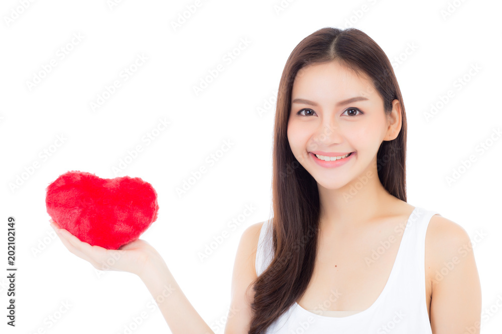 Portrait of beautiful asian young woman holding red heart shape pillow and smile isolated on white background, valentines day, holiday concept. Portrait of beautiful asian young woman holding red heart shape pillow and smile isolated on white background, valentines day, holiday concept.