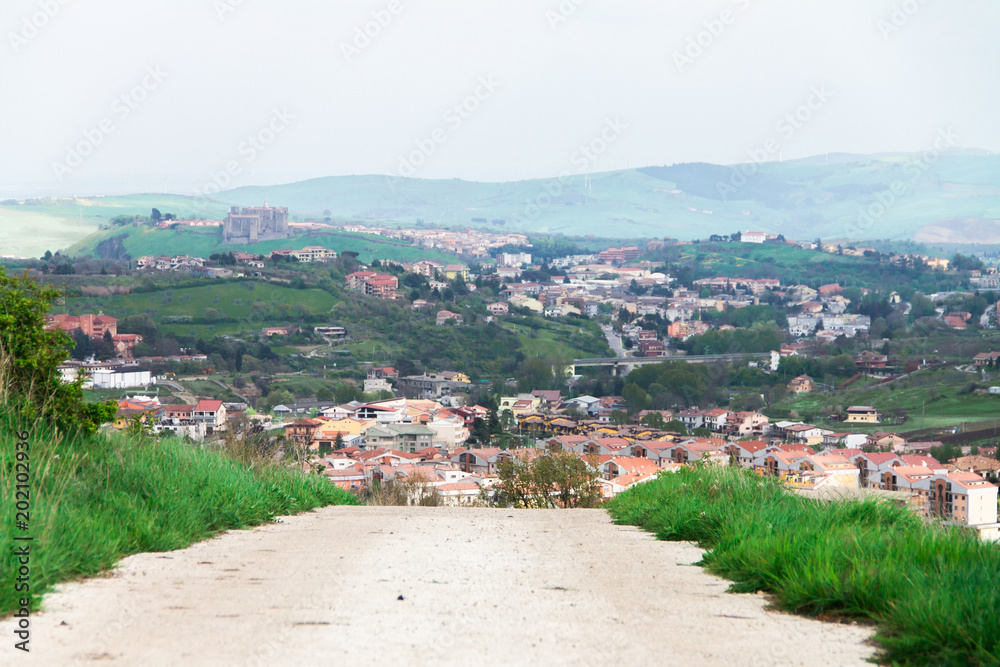 the view of the city from the mountains, the Italian house at the foot of the mountains, town between mountains, panoramic landscape of the city