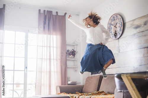 beautiful caucasian woman jump at home photo