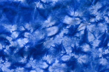 Pattern of blue dye on cotton cloth, Dyed indigo fabric background and textured