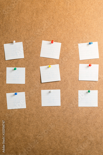 nine white stickers for taking notes on a cardboard background