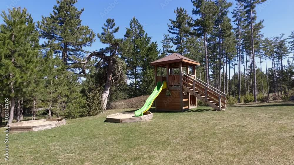 childhood equipment and object concept - climbing frame house with slide on playground park outdoors at summer childhood equipment and object concept - climbing frame house with slide on playground park outdoors at summer